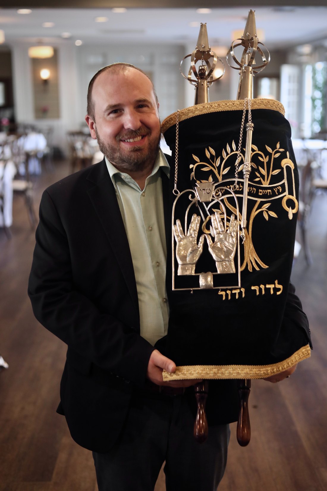 Ben Russell holding a Torah scroll